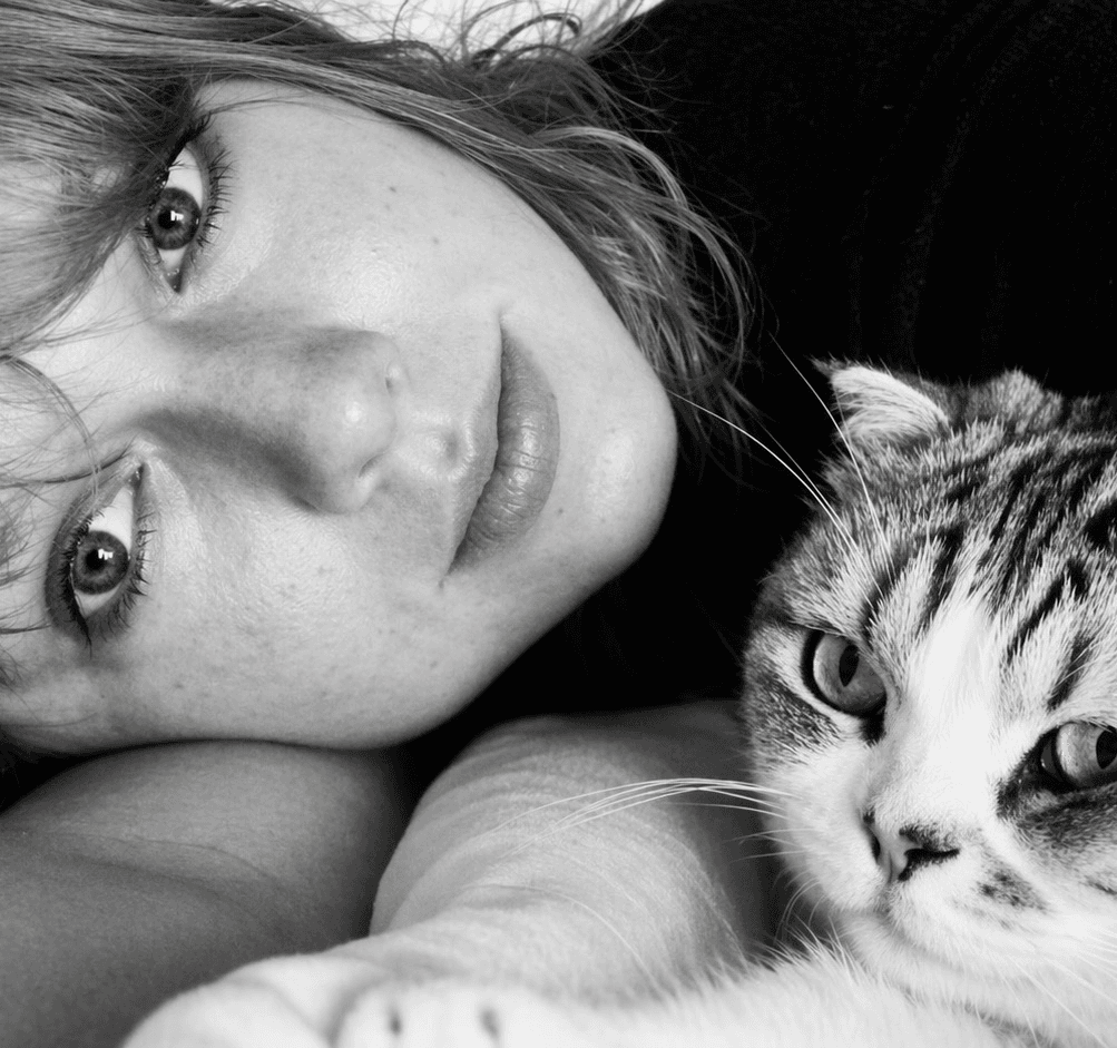 Woman lying with a tabby cat