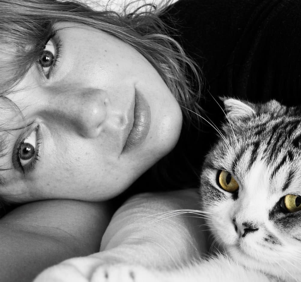 Woman lying with a tabby cat